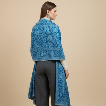 Woman wearing a blue lace shawl over a beige background