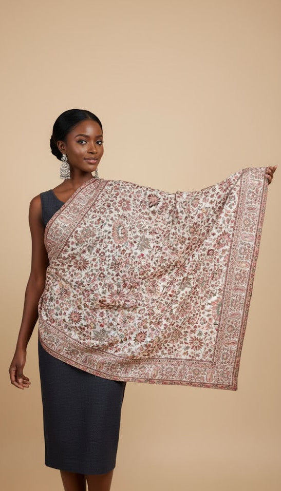 Woman wearing a patterned floral pure wool shawl in kani design on a beige background