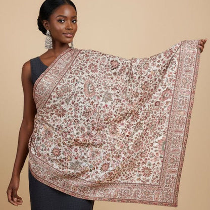 Woman wearing a patterned floral pure wool shawl in kani design on a beige background