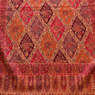 Decorative rug with intricate patterns on a wooden floor