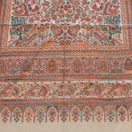 Long, patterned rug on a wooden floor