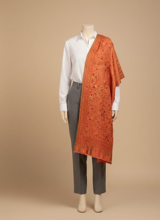 Mannequin wearing a white shirt, gray pants, and a folded pink pure wool shawl on a beige background