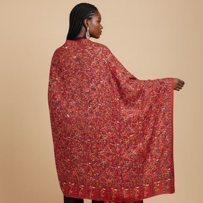 Woman wearing a red patterned stole on a beige background