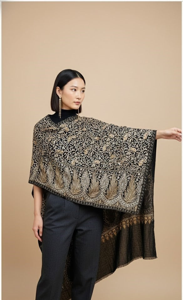 Woman wearing a black and gold patterned shawl on a beige background